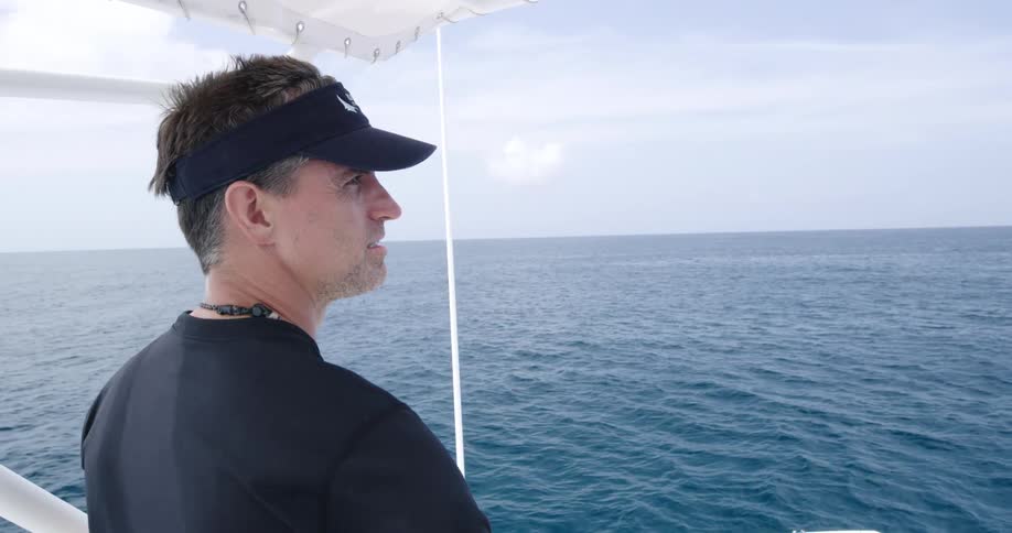 A man is traveling on a boat through the ocean