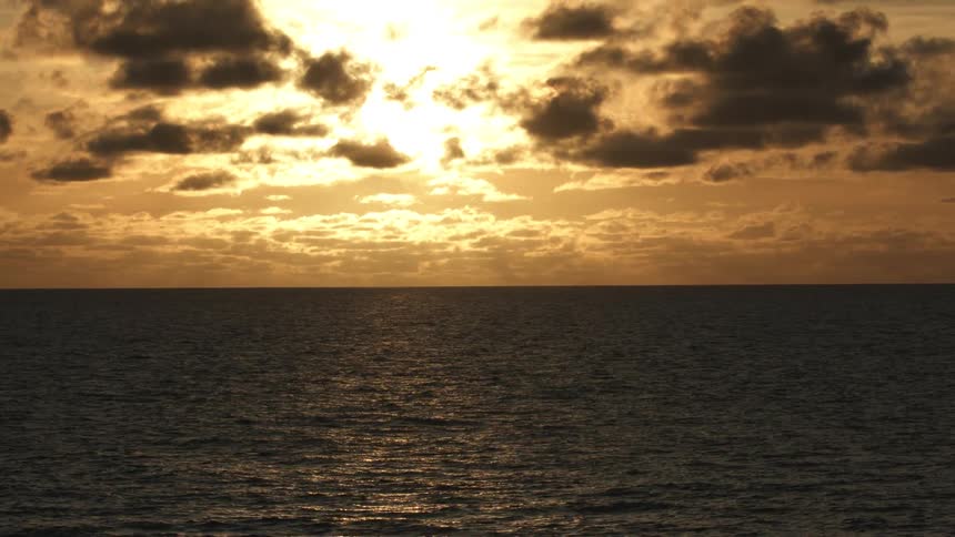 Sunlight reflecting on the waves of the ocean at sunset