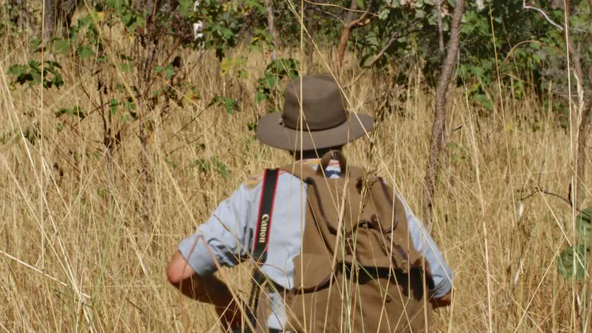 A man is hiking through the wilderness
