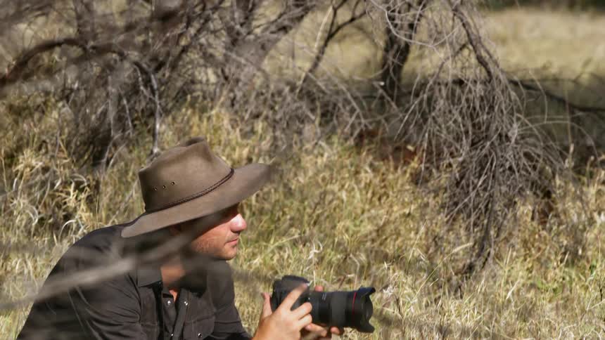 A male photographer taking photos outdoors