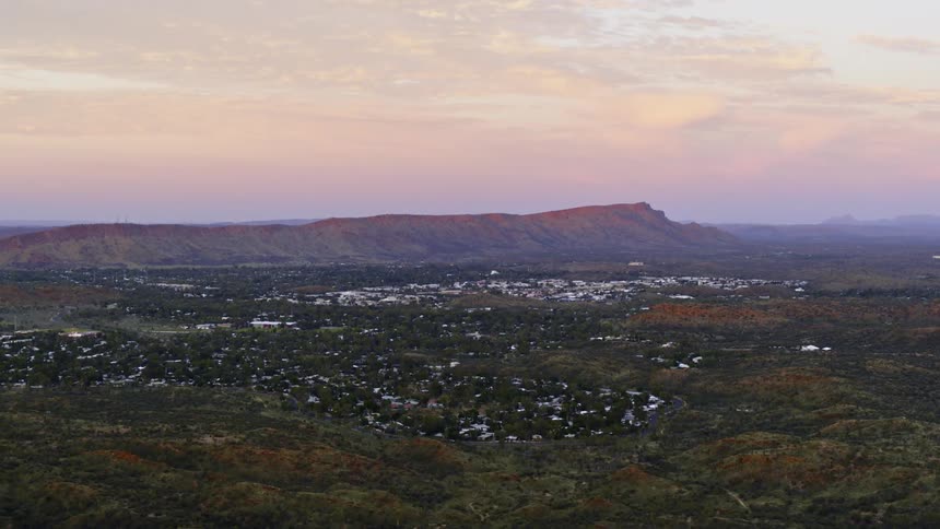 An aerial view of a landscape at dusk is displayed