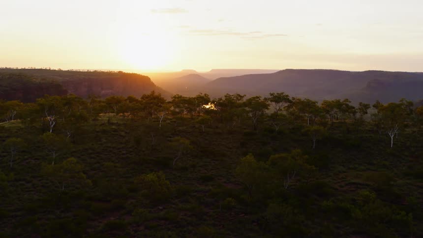 A vast valley between mountain ridges with a road running through it