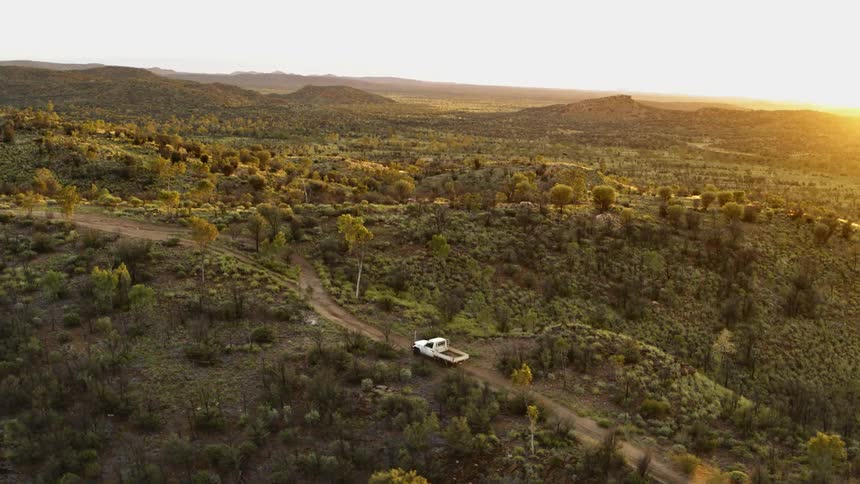 A truck is driving on a road in the country