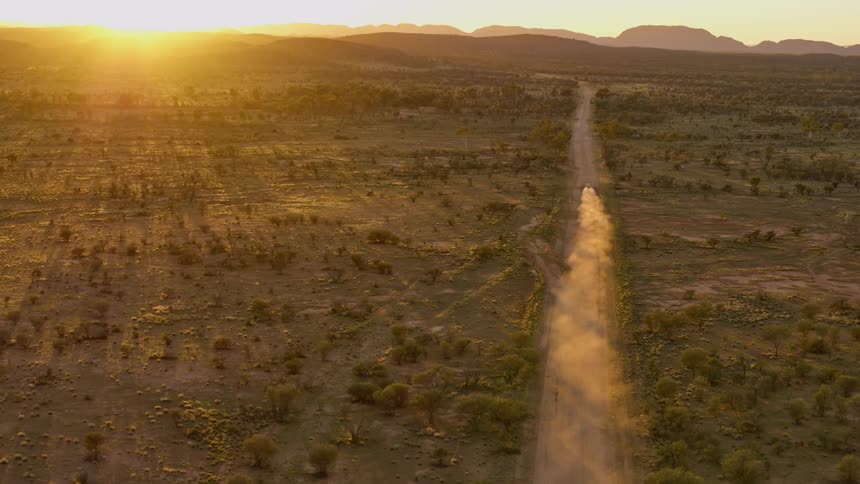 An aerial view of a landscape at dawn or dusk is displayed