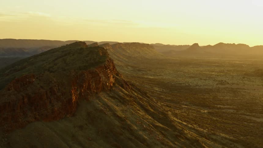 The sun sets over a mountain landscape