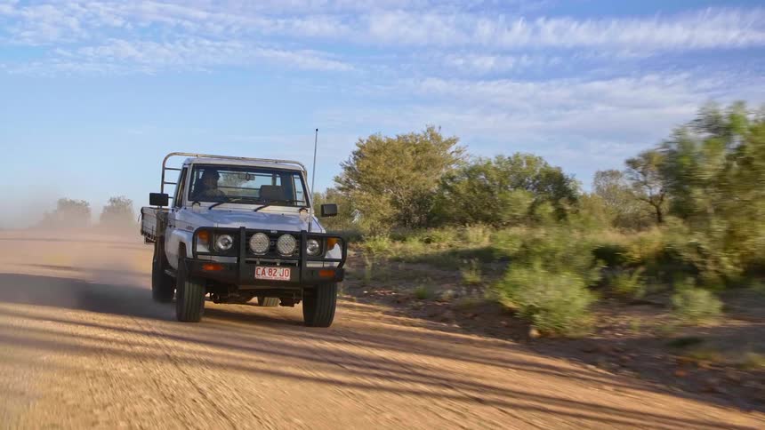All terrain vehicle driving on a dirt road at day
