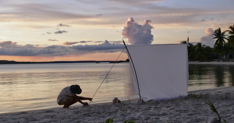 A man is by the beach at dusk