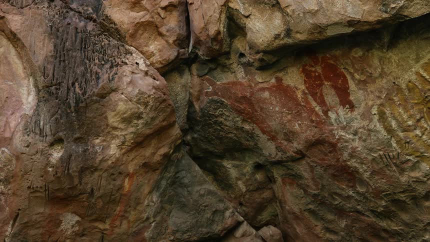 A primitive wall painting on the face of a rock formation