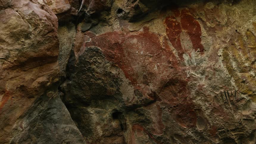 Artwork is painted and carved on the rocks