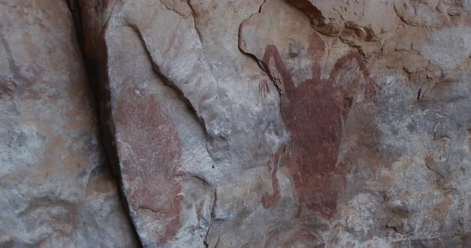 Ancient archaeological painting on a vertical rock wall