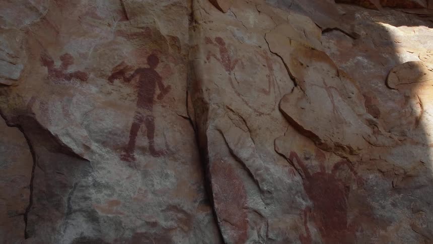 Ancient archaeological paintings on the vertical rock wall