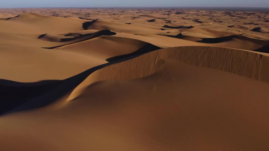 Anaerial view of sand dunes in a desert on a clear day
