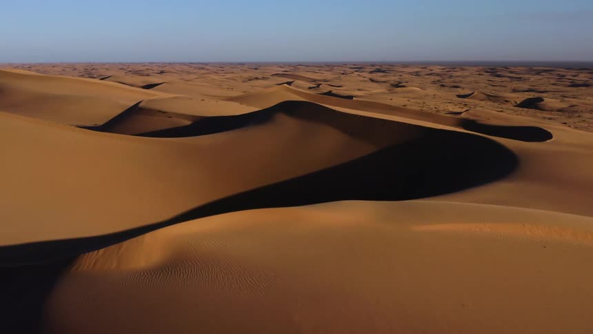 An aerial view of sand dunes in a remote desert