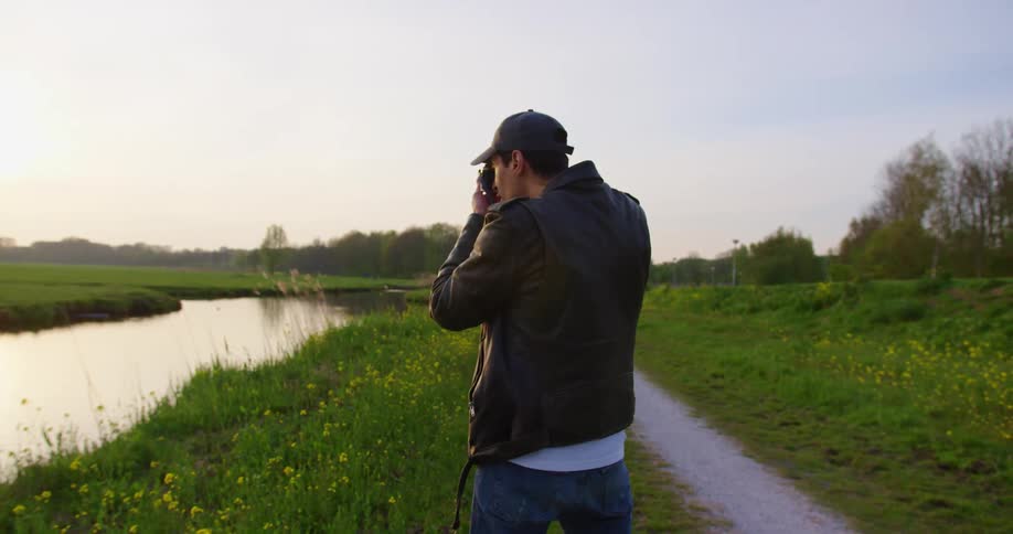 A man is taking pictures of nature