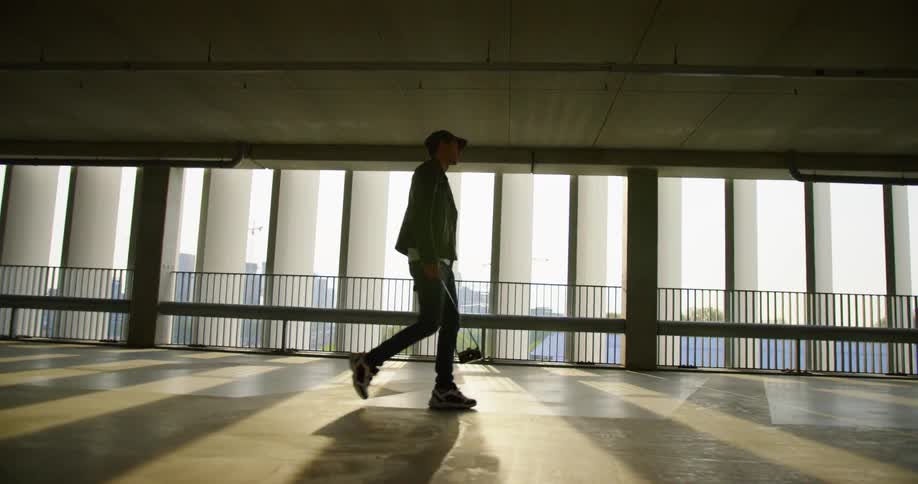 A man walks through the building carrying his camera