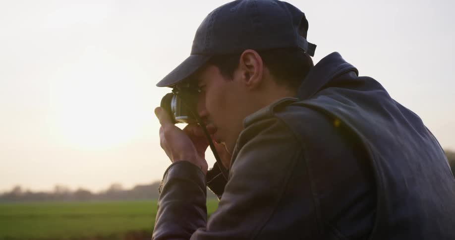 A young man takes pictures of the landscape