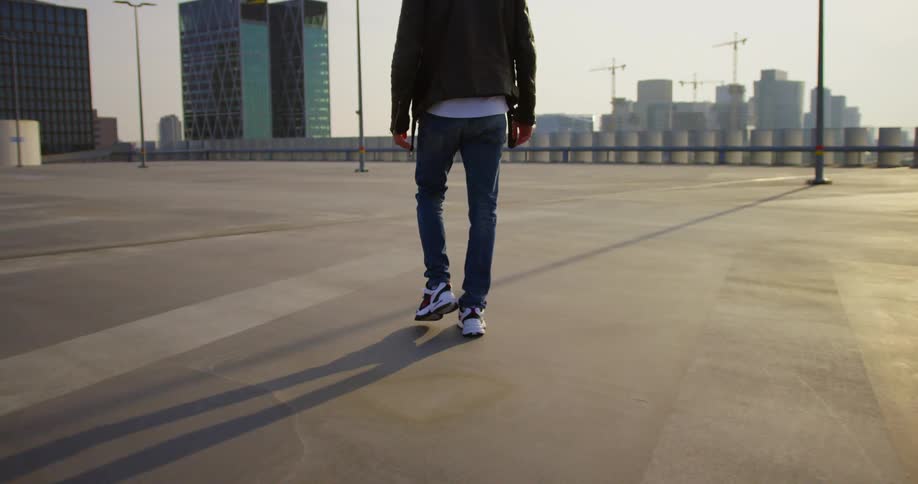 A man is walking in a downtown city