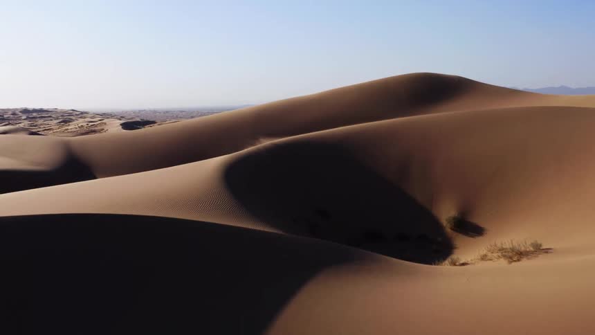 The tall dunes give off a black shadow