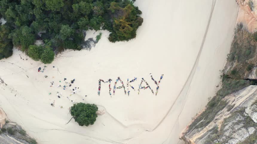 Text on a beach next to cliffs