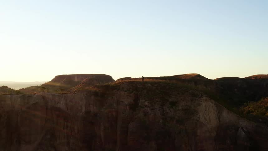 A person hiking along the edge of a cliff