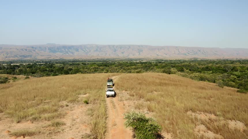 Cars are driving off road in a rural area