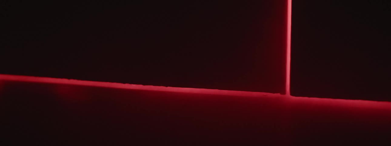 Red light and smoke move in under the door