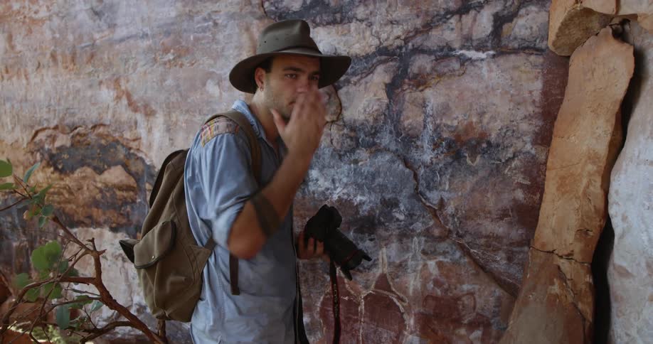 A man is outdoors and taking pictures