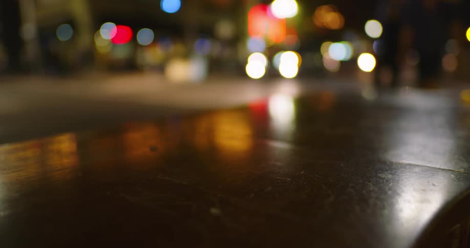 Downtown city area at night with cars and people walking