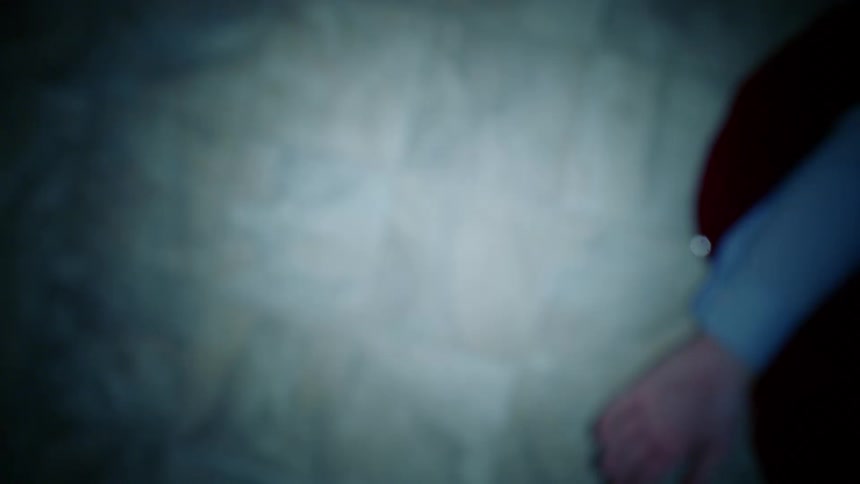 A person is laying on the ground in a pool of blood