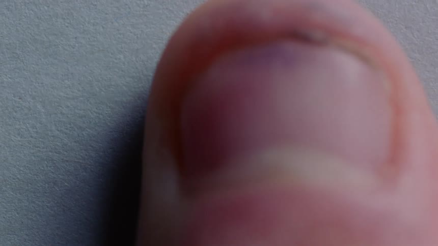 A person is using ink to make a finger print
