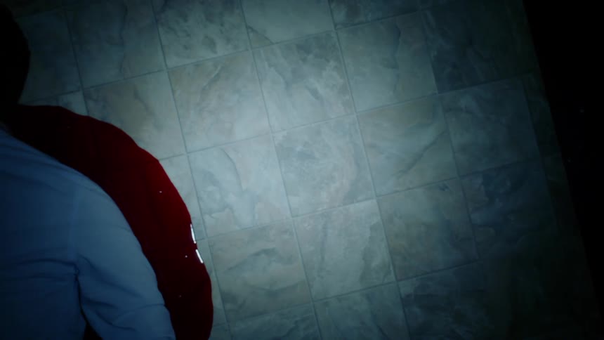 A man lying in a pool of blood on a floor
