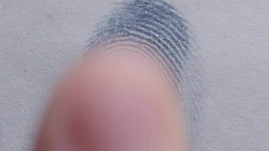 A person is putting there finger print on a wall