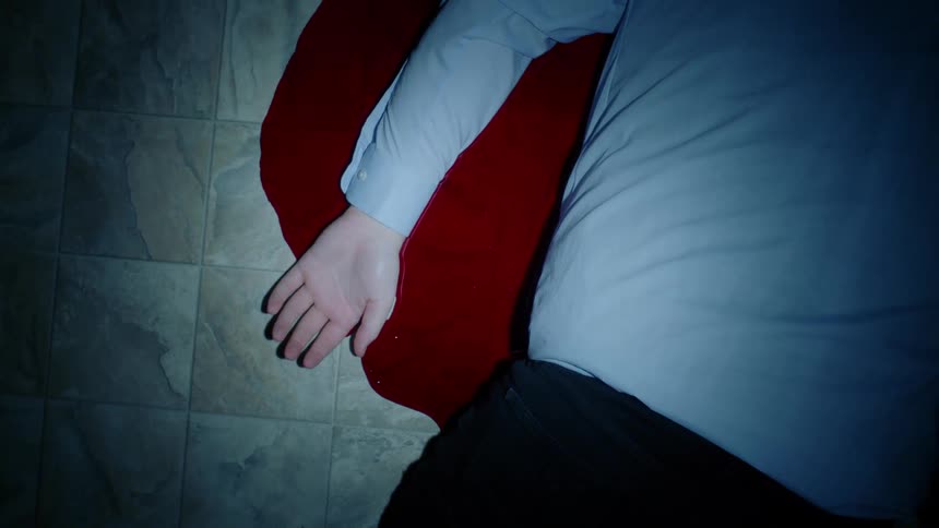 A man lying in a pool of blood