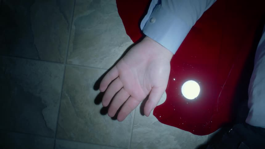 A man lying in a pool of blood