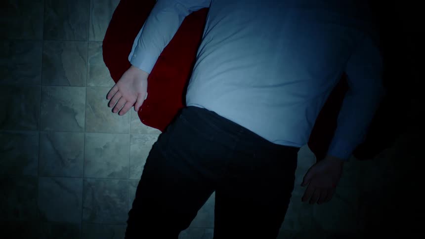 A man lying in a pool of blood