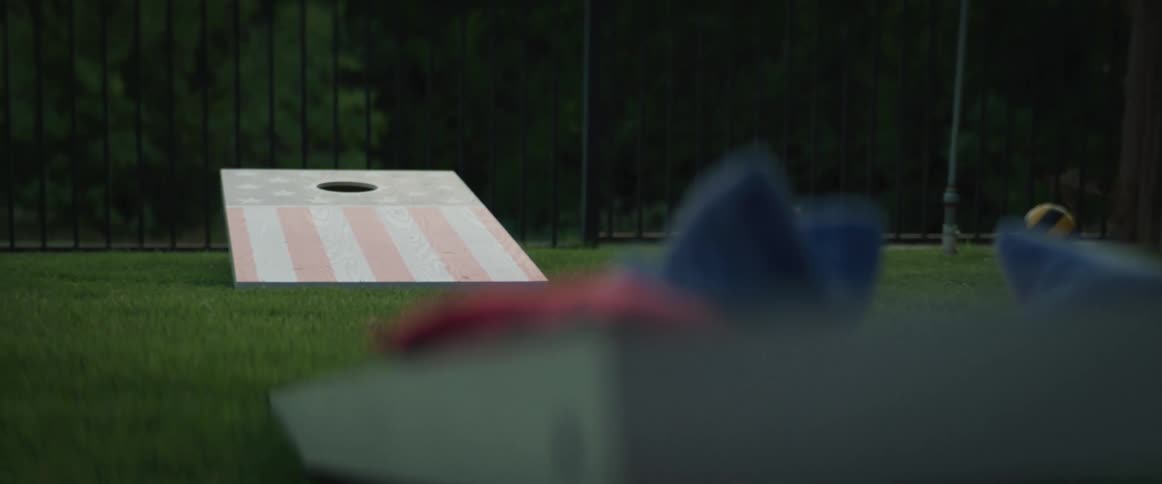 A corn hole board in a back yard