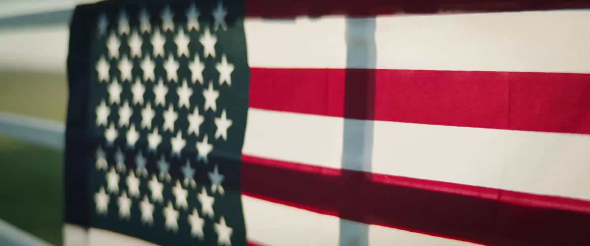 An american flag is hanging on the railing