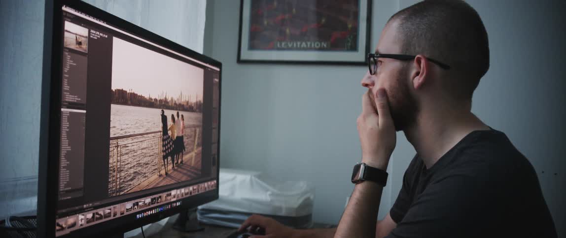A man is looking at a computer indoors