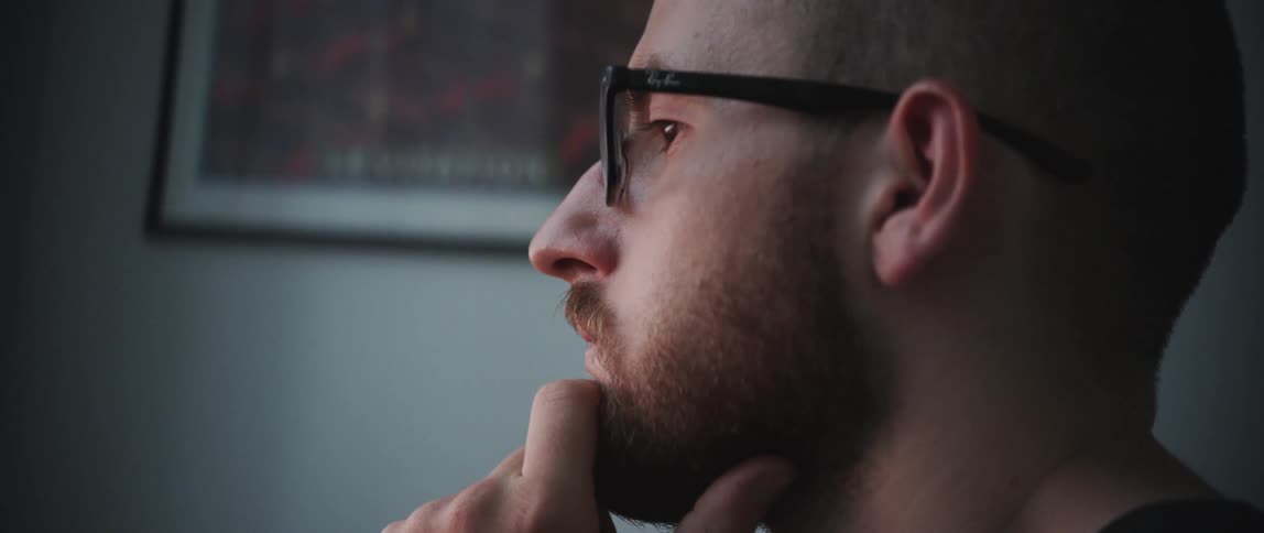 A man is sitting inside his house