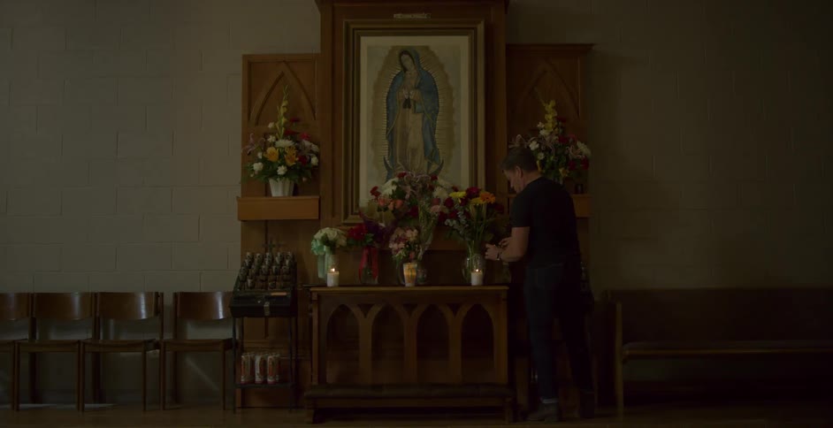 Man lights a candle in a church