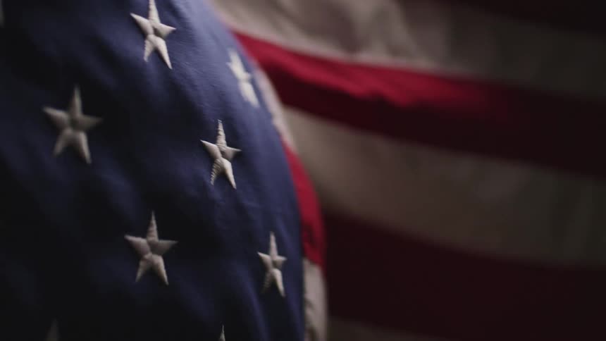 Close up of the american flag swaying in the wind