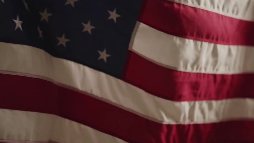 An american flag billowing in the wind