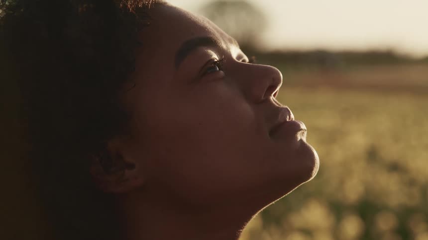 A young woman looking up at the sky