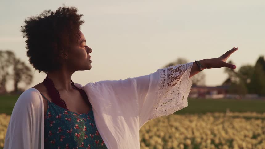 Woman reaching out in a field