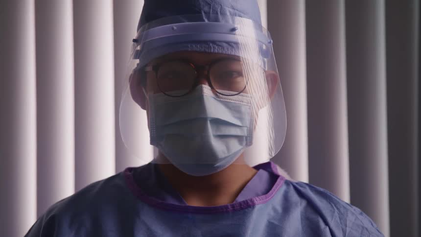 A doctor is wearing a face shield