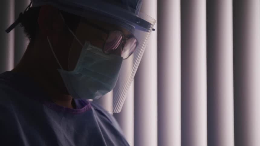 A doctor in a dimly lit room