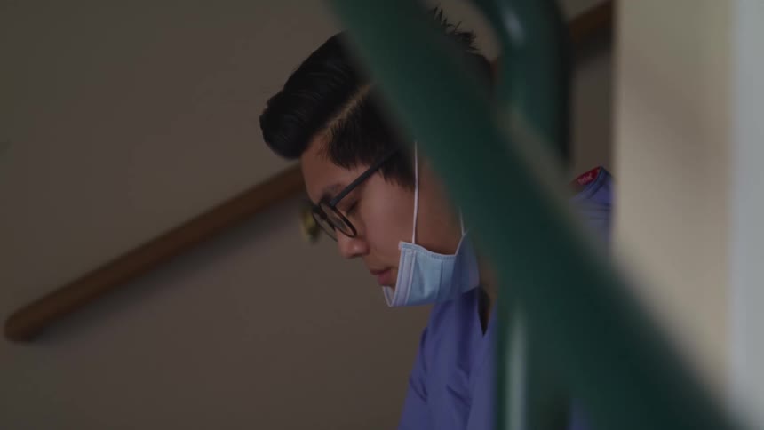 A doctor is resting in the stairwell
