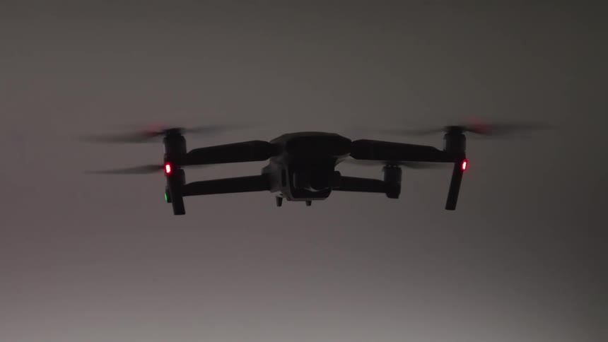 A drone is flying in place with blinking lights
