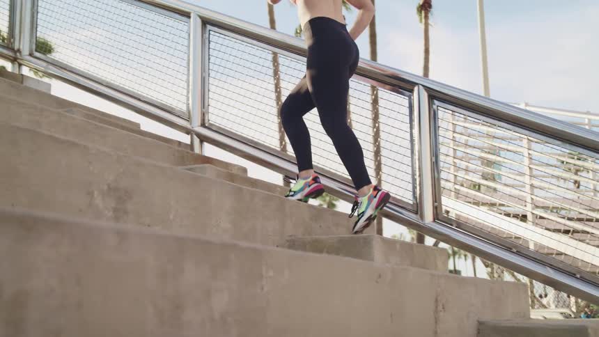 A woman is climbing up the steps