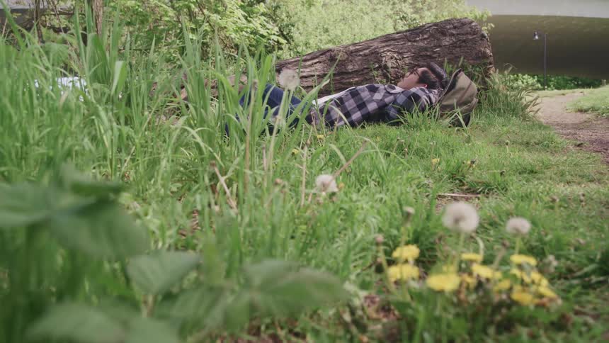 A teenage boy lying in the grass